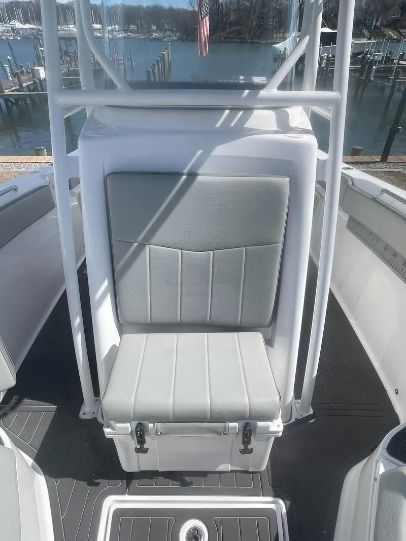 Slide: The Image of 2022 Aquasport 2100 CC boat seat with gray upholstery, dockside view. - 24