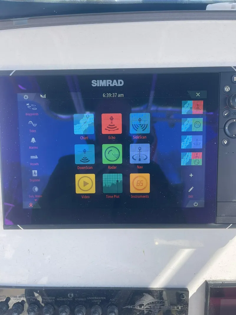 Slide: The Image of Simrad display on 2022 Aquasport 2100 CC boat, showing navigation and control interface. - 27