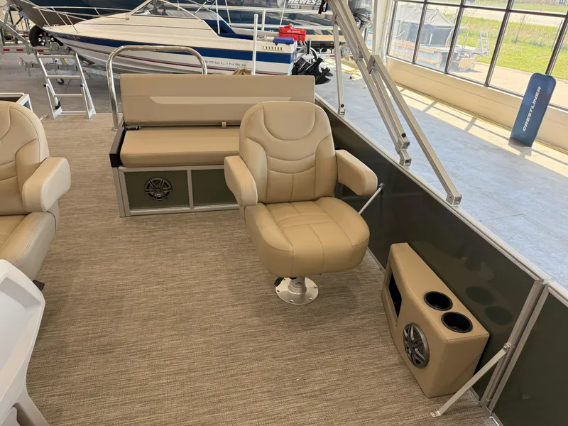 Slide: The Image of 2025 Godfrey EX2086SFLX Tritoon interior with beige seating and cup holders. - 12