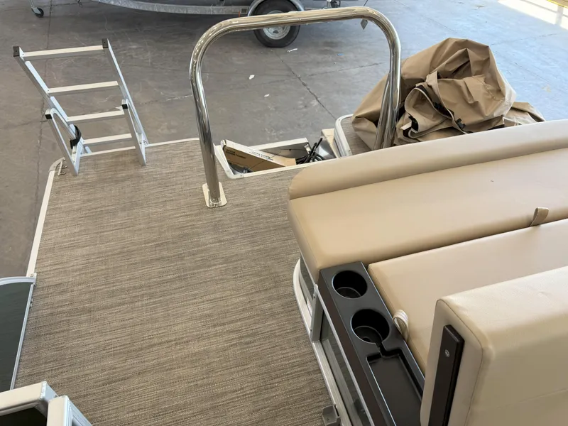 Slide: The Image of 2025 Godfrey EX2086SFLX Tritoon deck with seating, ladder, and cup holders. - 13