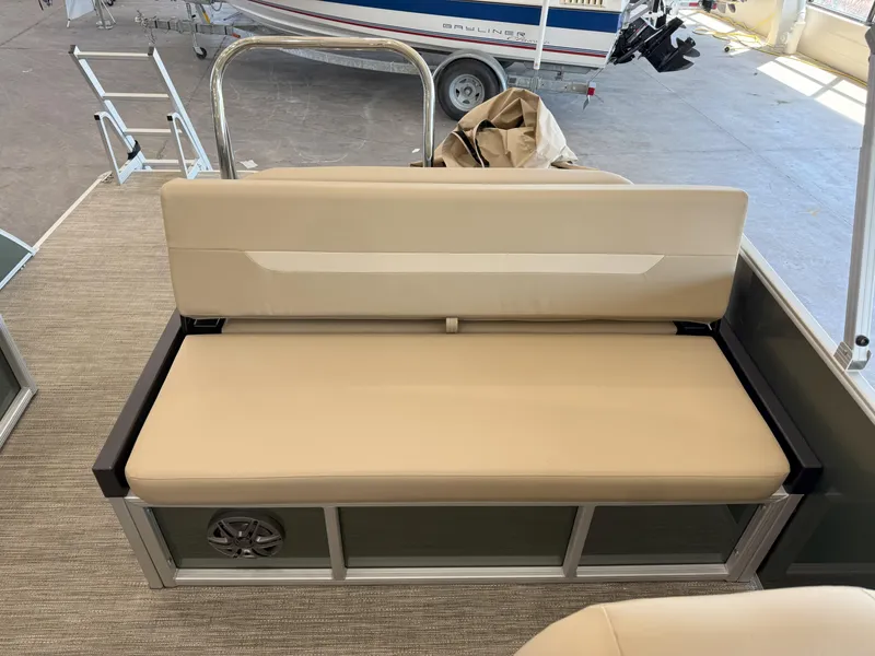 Slide: The Image of 2025 Godfrey EX2086SFLX Tritoon boat seat with beige upholstery and speaker. - 14