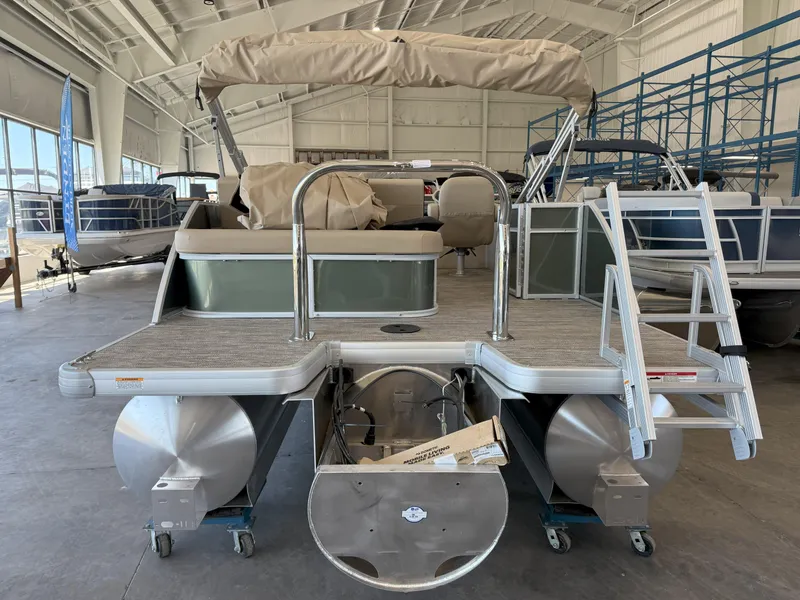 Slide: The Image of 2025 Godfrey EX2086SFLX Tritoon in showroom, rear view with ladder and canopy. - 7