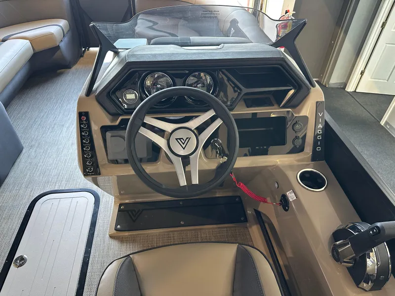 Slide: The Image of Interior view of 2025 Viaggio Lago X-U boat dashboard with steering wheel and controls. - 11