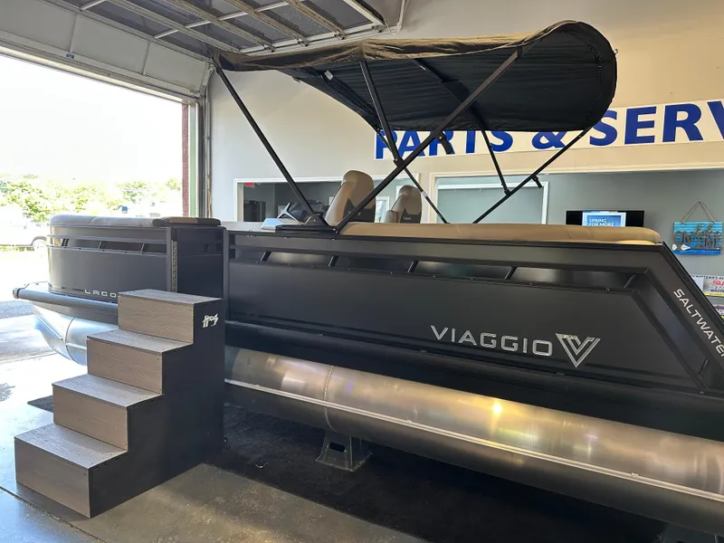 Slide: The Image of 2025 Viaggio Lago X-U pontoon boat displayed indoors with canopy and stairs. - 4