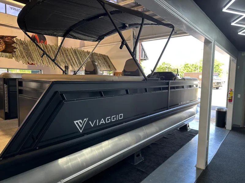 Slide: The Image of 2025 Viaggio Lago X-U pontoon boat displayed indoors with sleek design and canopy. - 5