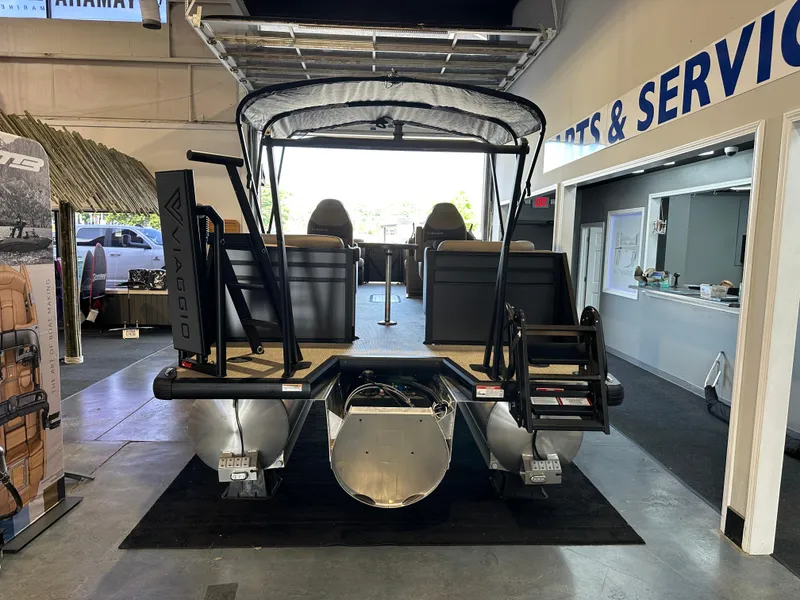 Slide: The Image of 2025 Viaggio Lago X-U pontoon boat displayed in showroom, featuring modern design and seating. - 6