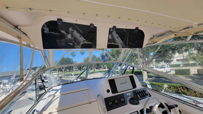 Slide: The Image of 2004 Grady-White Marlin 300 boat cockpit with steering wheel and navigation system. - 12