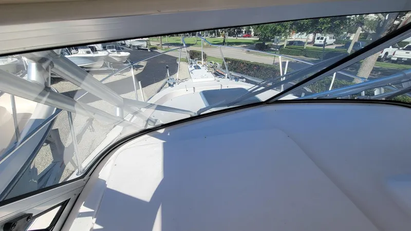 Slide: The Image of 2004 Grady-White Marlin 300 boat interior view with clear windows and outdoor scenery. - 13