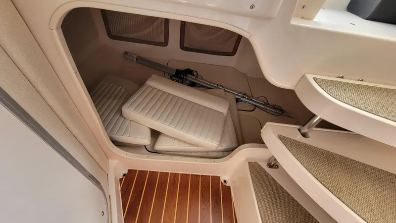 Slide: The Image of 2004 Grady-White Marlin 300 cabin storage area with cushions and equipment. - 19