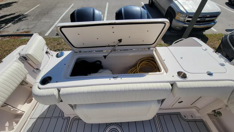 Slide: The Image of 2004 Grady-White Marlin 300 boat with open storage compartment and twin engines. - 21