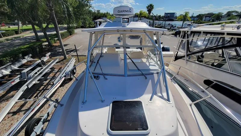 Slide: The Image of 2004 Grady-White Marlin 300 boat with Garmin equipment, docked under clear skies. - 24