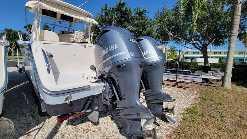 Slide: The Image of 2004 Grady-White Marlin 300 boat with twin Yamaha outboard engines, parked outdoors. - 25