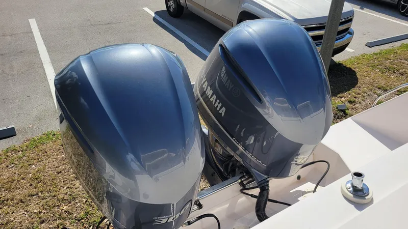 Slide: The Image of Twin Yamaha outboard motors on a 2004 Grady-White Marlin 300 boat in a parking lot. - 5