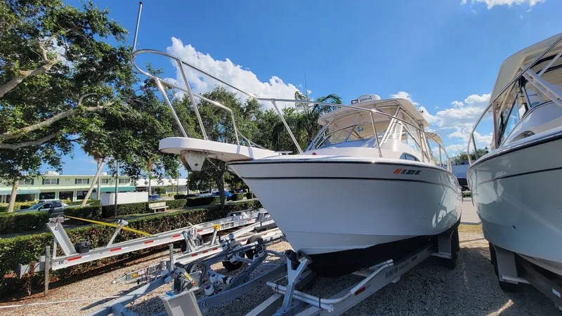 Slide: The Image of 2004 Grady-White Marlin 300 boat on trailer under clear blue sky. - 7