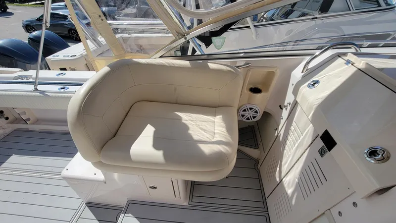 Slide: The Image of 2004 Grady-White Marlin 300 boat interior with beige seating and control panel. - 9