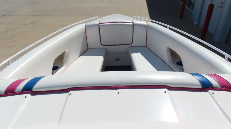 Slide: The Image of 1998 Eliminator 28 EAGLE XP boat interior with white seating and colorful accents. - 10