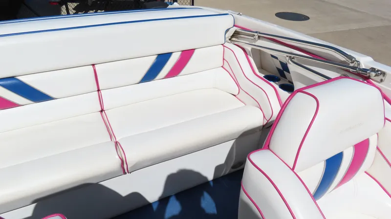Slide: The Image of 1998 Eliminator 28 EAGLE XP boat interior with white, pink, and blue upholstery. - 12