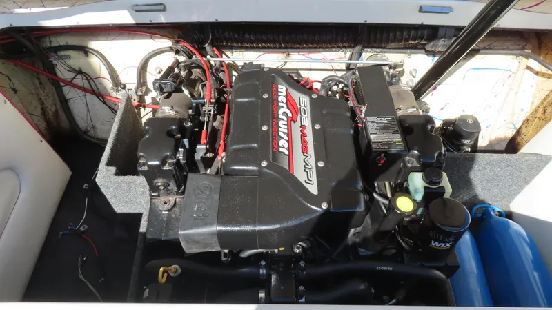 Slide: The Image of Engine compartment of a 1998 Eliminator 28 EAGLE XP boat, featuring a MerCruiser engine. - 13