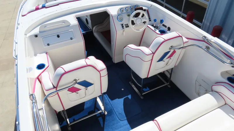 Slide: The Image of 1998 Eliminator 28 EAGLE XP boat interior with white and blue seating, dashboard, and steering wheel. - 6