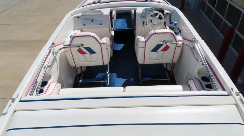 Slide: The Image of 1998 Eliminator 28 EAGLE XP boat interior with white and blue seating. - 7