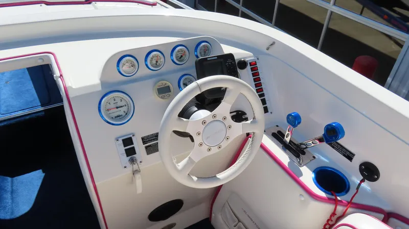 Slide: The Image of 1998 Eliminator 28 EAGLE XP boat dashboard with steering wheel and control gauges. - 8