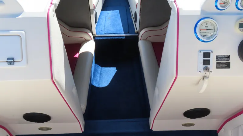 Slide: The Image of Interior of 1998 Eliminator 28 EAGLE XP boat with blue carpet and white seating. - 9