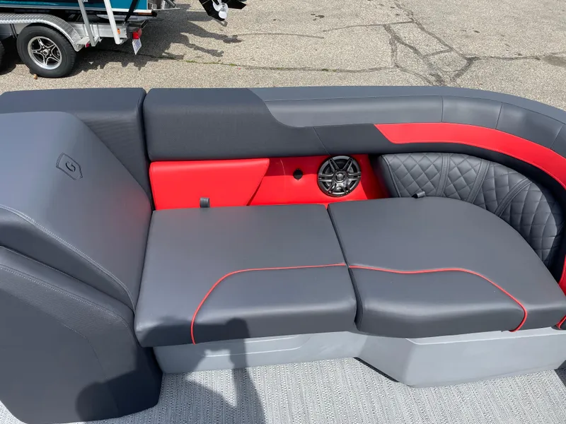 Slide: The Image of 2025 Godfrey SW2286SFLC Tritoon in showroom, red exterior, on trailer. - 2