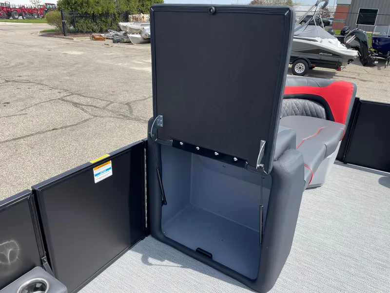 Slide: The Image of 2025 Godfrey SW2286SFLC Tritoon boat interior with open storage compartment and seating. - 22