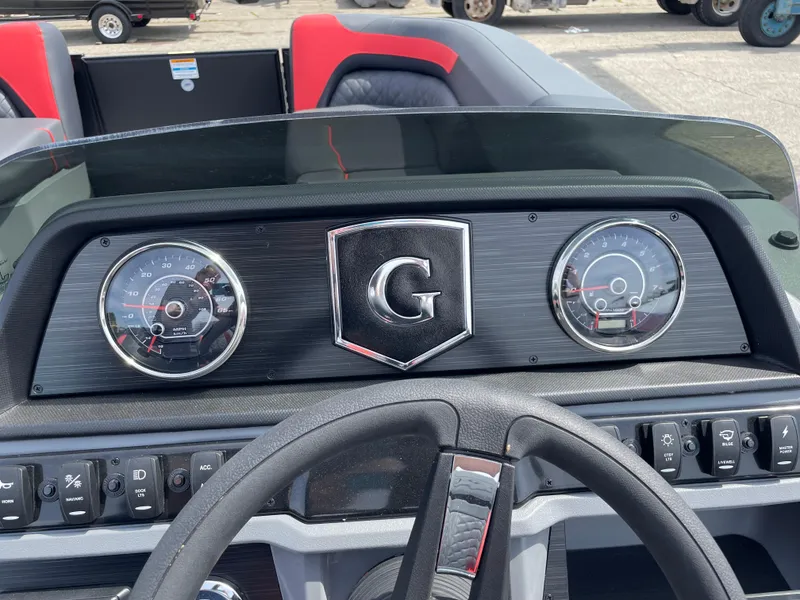 Slide: The Image of 2025 Godfrey SW2286SFLC Tritoon interior with gray and red seating, featuring a speaker. - 7