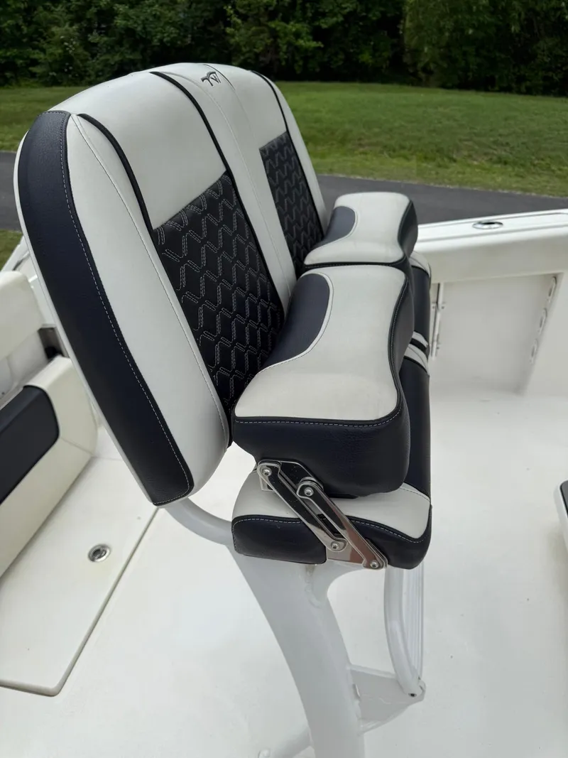Slide: The Image of 2021 Tidewater 220 CC boat seat with black and white upholstery. - 14