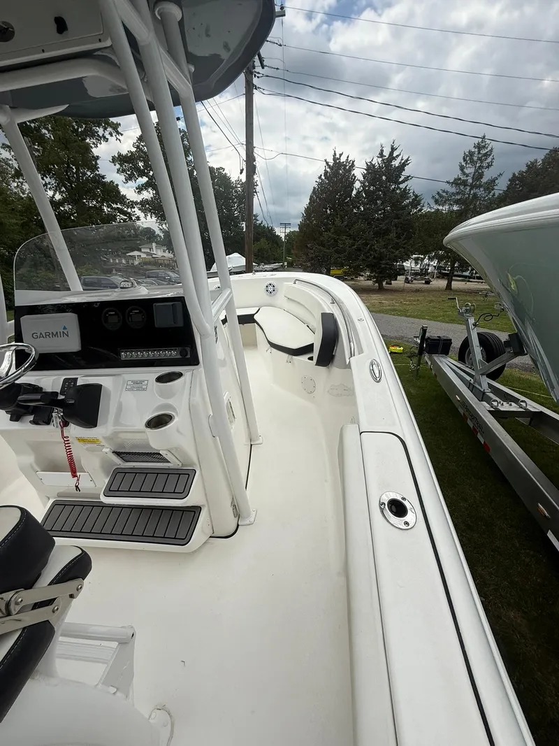 Slide: The Image of 2021 Tidewater 220 CC boat with sleek design, featuring a spacious deck and modern controls. - 22