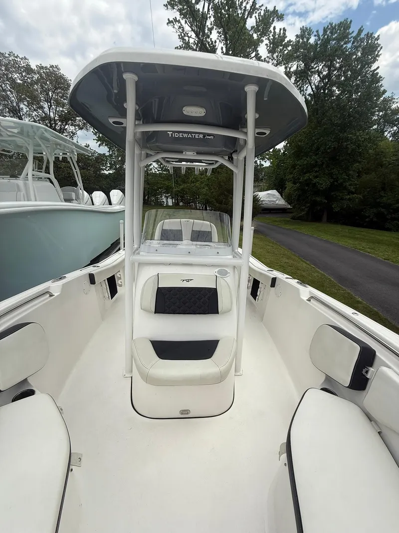 Slide: The Image of 2021 Tidewater 220 CC boat with T-top, white seating, and spacious deck. - 23