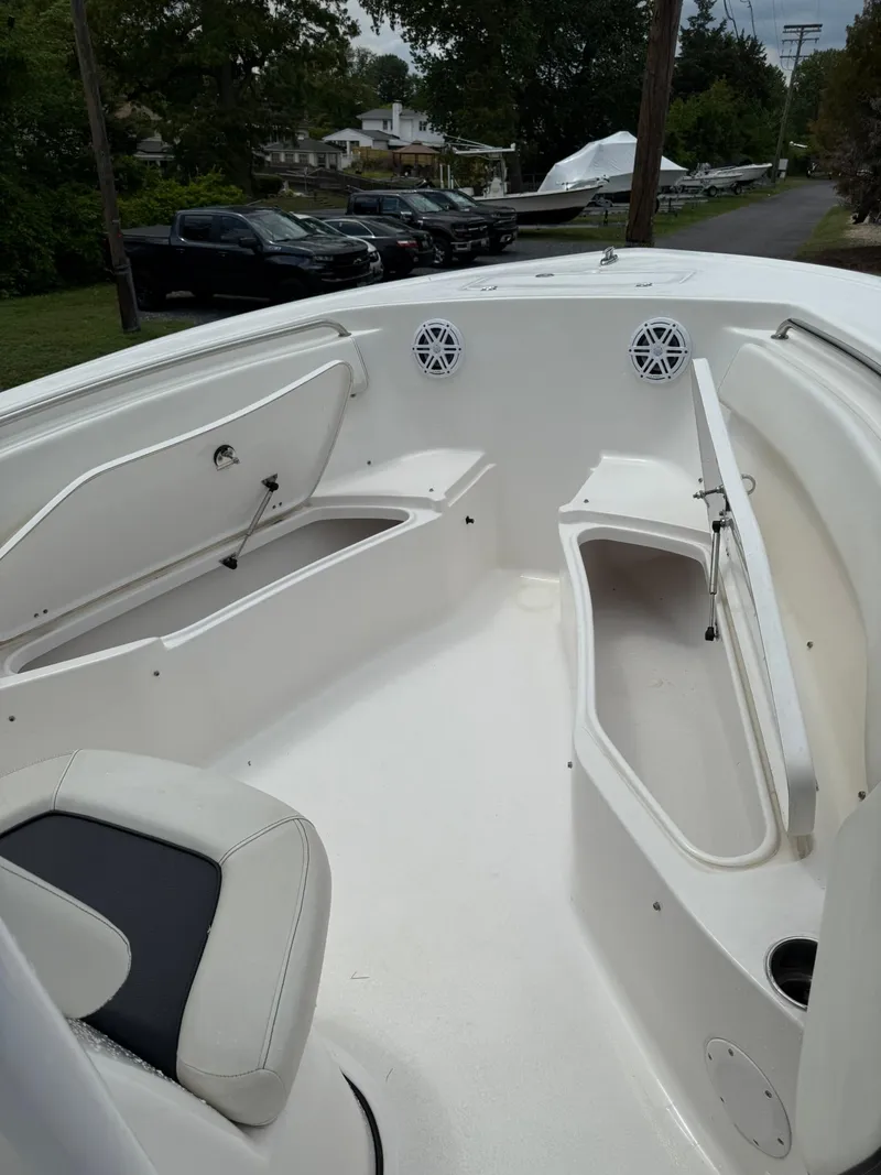 Slide: The Image of 2021 Tidewater 220 CC boat interior with seating and storage compartments. - 9