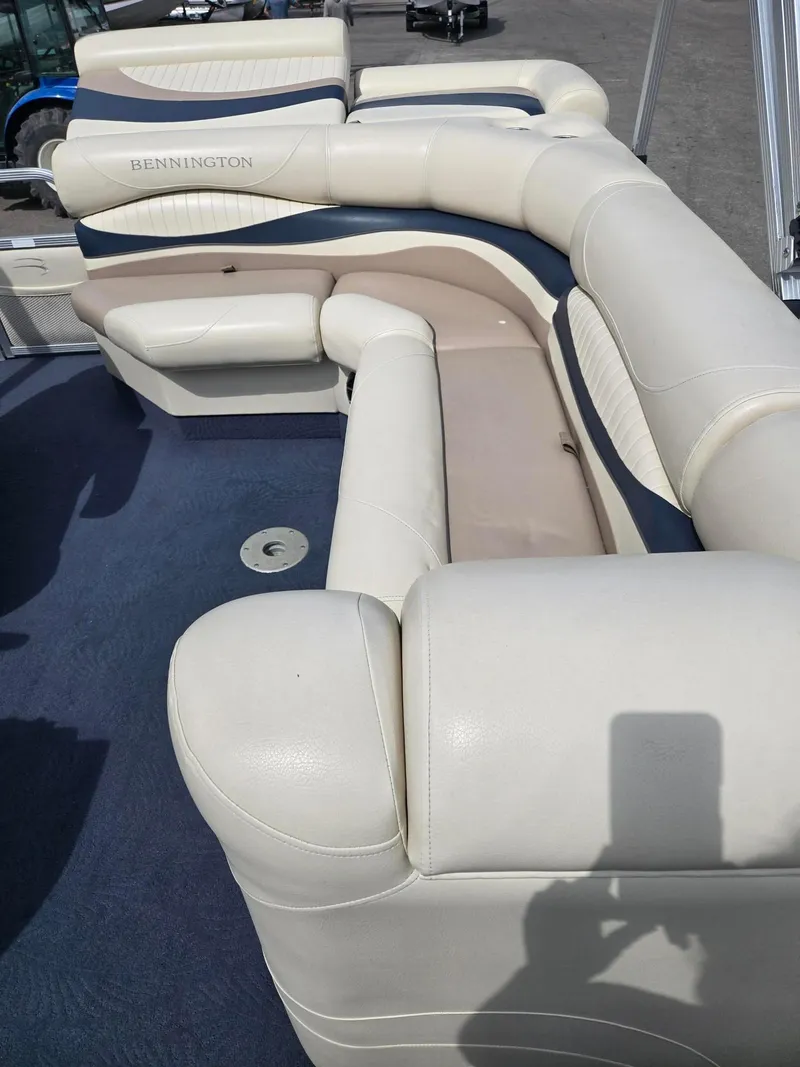 Slide: The Image of 2008 Bennington 2050 RL boat interior with white and blue seating. - 11