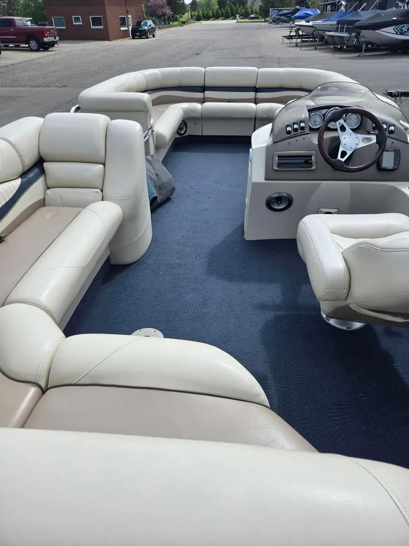 Slide: The Image of 2008 Bennington 2050 RL pontoon boat interior with beige seating and steering console. - 12