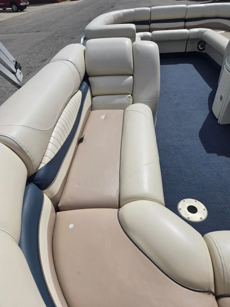Slide: The Image of 2008 Bennington 2050 RL boat interior with beige and blue seating. - 13
