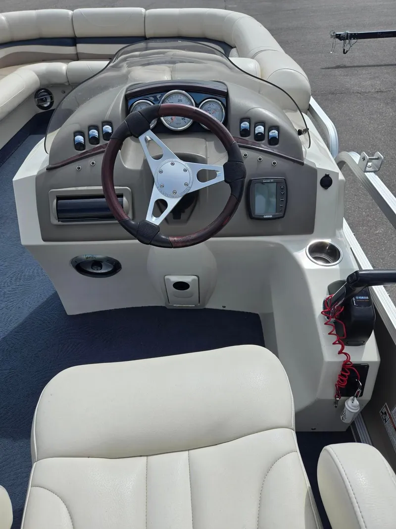 Slide: The Image of 2008 Bennington 2050 RL boat dashboard with steering wheel and control panel. - 14