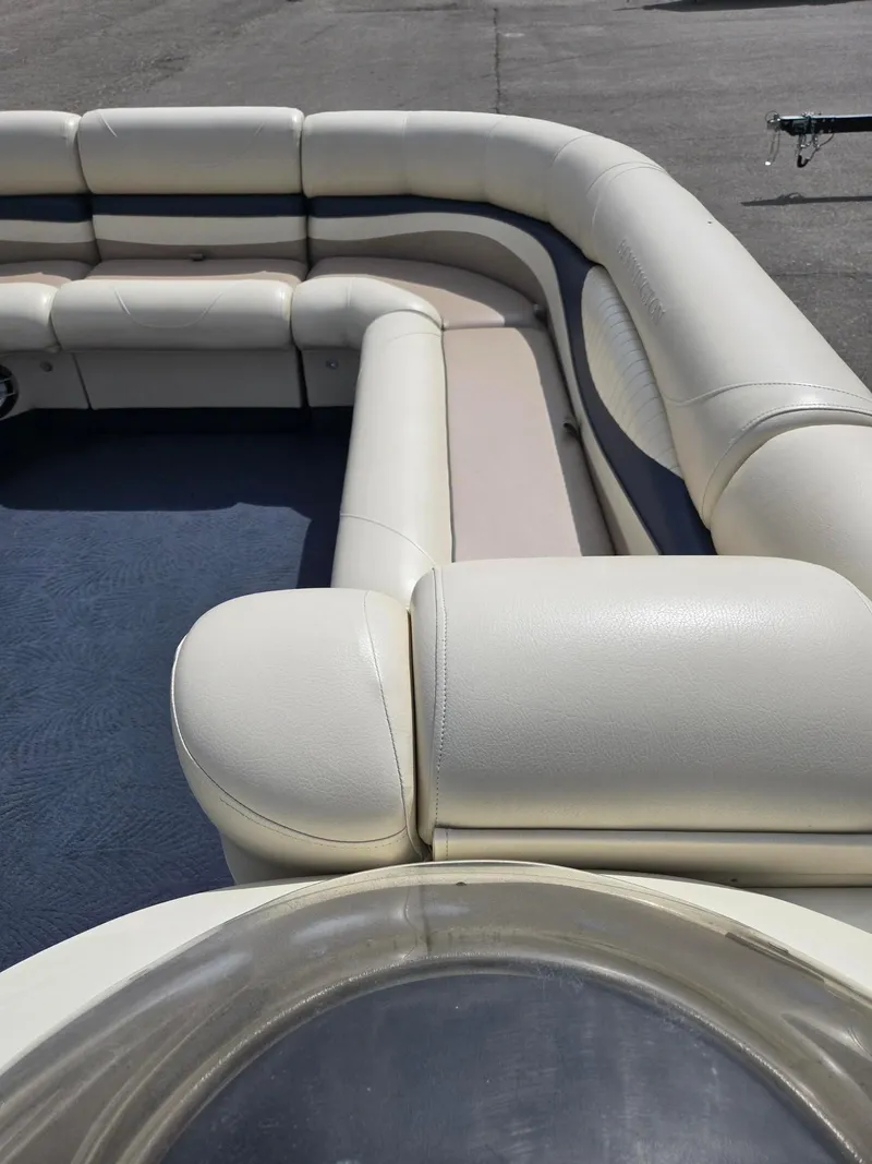 Slide: The Image of 2008 Bennington 2050 RL boat interior with white cushioned seating. - 16