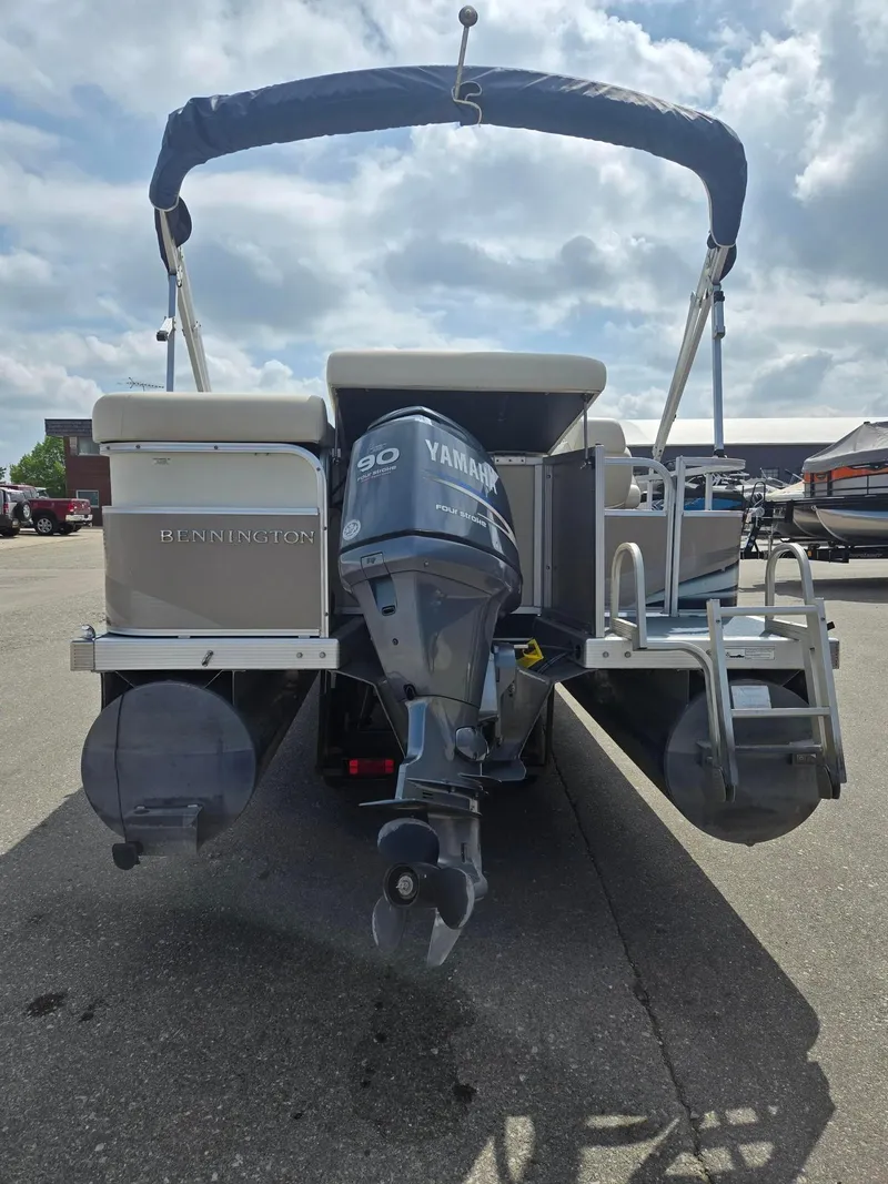 Slide: The Image of 2008 Bennington 2050 RL pontoon boat with Yamaha 90 outboard motor, parked outdoors. - 3