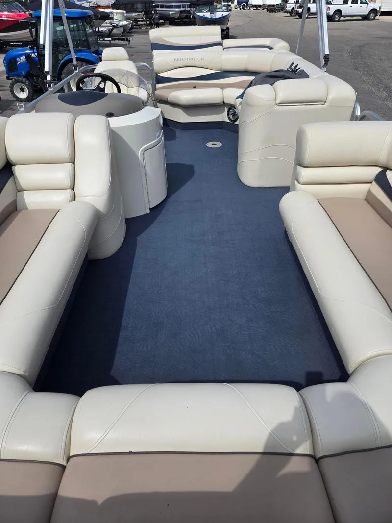 Slide: The Image of 2008 Bennington 2050 RL pontoon boat interior with beige seating and blue flooring. - 7