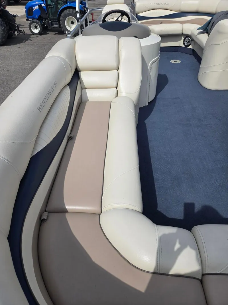 Slide: The Image of 2008 Bennington 2050 RL boat interior with beige seating and blue flooring. - 8