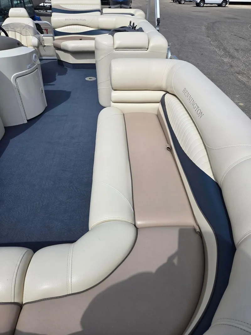 Slide: The Image of 2008 Bennington 2050 RL boat interior with beige and blue seating. - 9