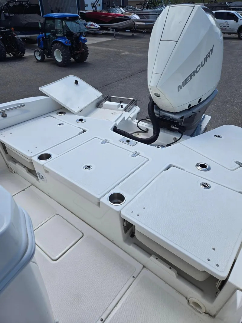 Slide: The Image of 2022 Boston Whaler Dauntless 250 boat with Mercury engine, docked in a marina. - 11