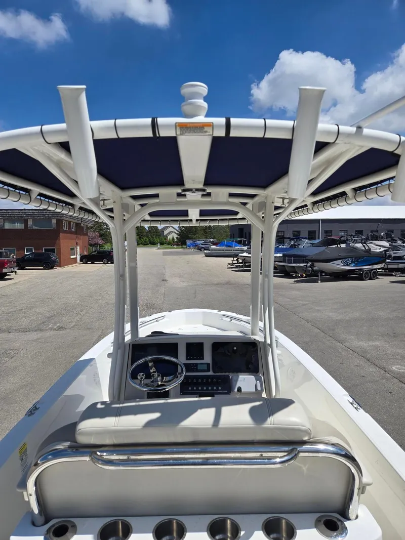 Slide: The Image of 2022 Boston Whaler Dauntless 250 boat interior with steering console and T-top. - 16