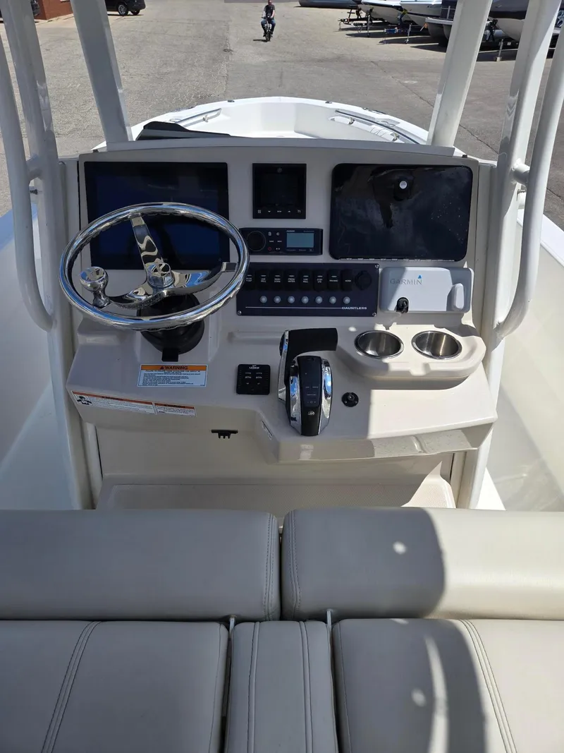 Slide: The Image of 2022 Boston Whaler Dauntless 250 boat console with steering wheel and controls. - 19
