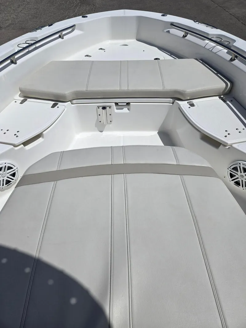 Slide: The Image of 2022 Boston Whaler Dauntless 250 boat interior with cushioned seating and sleek design. - 22