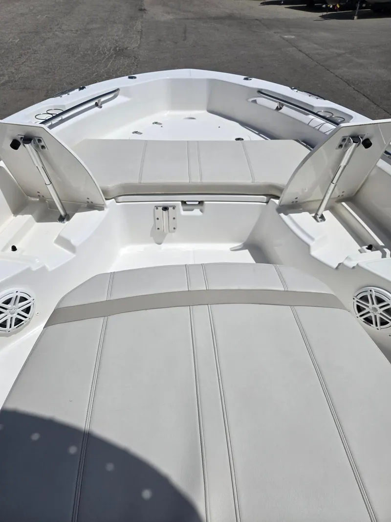 Slide: The Image of 2022 Boston Whaler Dauntless 250 boat interior with seating and storage compartments. - 23