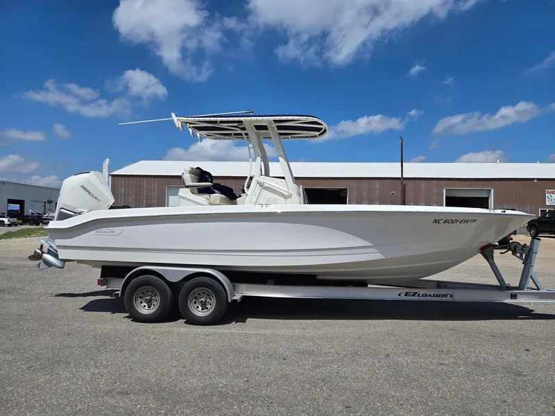 Slide: The Image of 2022 Boston Whaler Dauntless 250 boat on trailer under blue sky. - 5