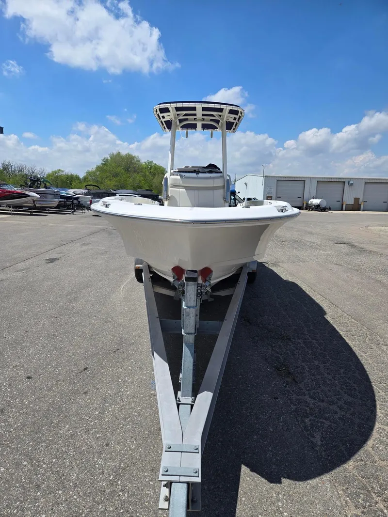 Slide: The Image of 2022 Boston Whaler Dauntless 250 boat on trailer under blue sky. - 6
