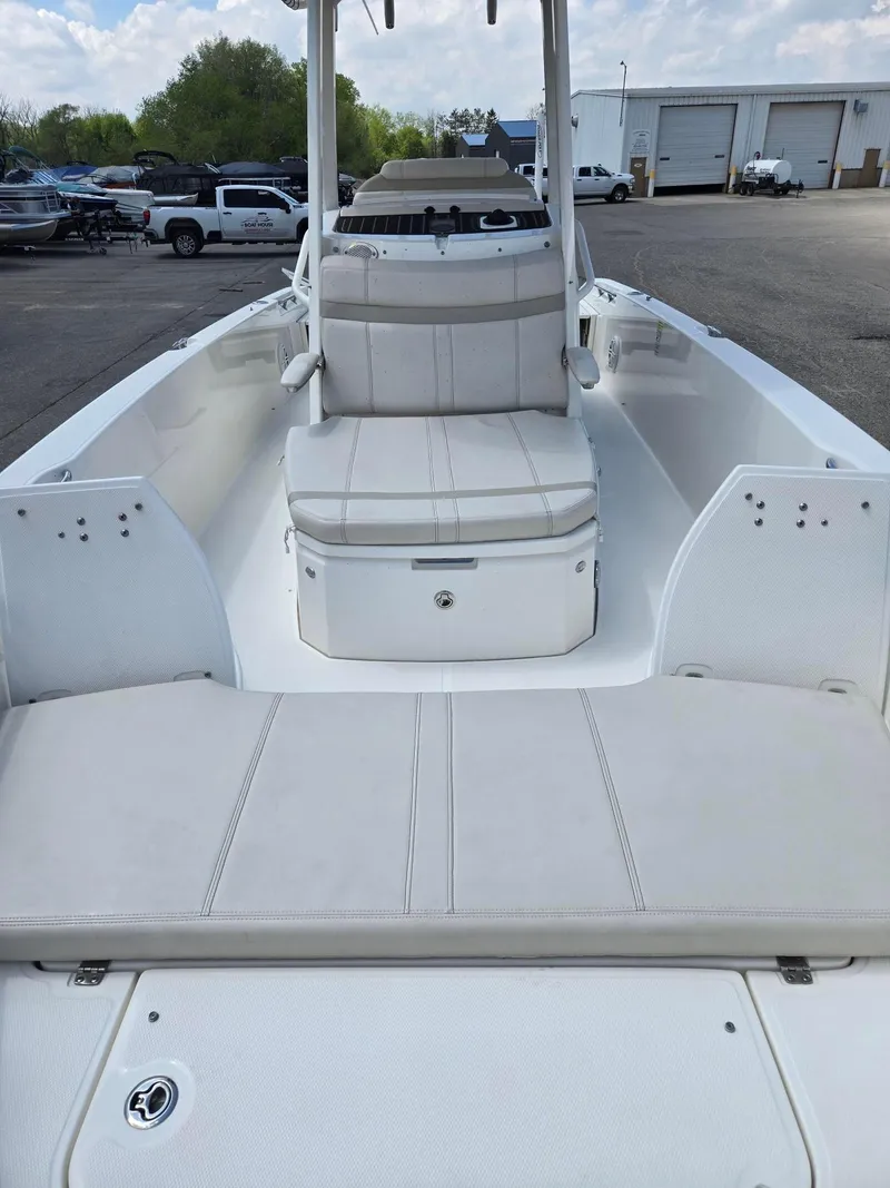 Slide: The Image of 2022 Boston Whaler Dauntless 250 boat interior with cushioned seating and storage. - 8